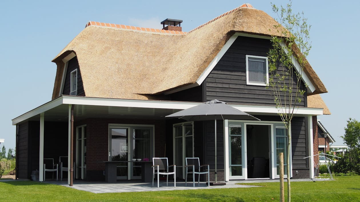 Restored craftsman cottage with original porch columns and wood windows